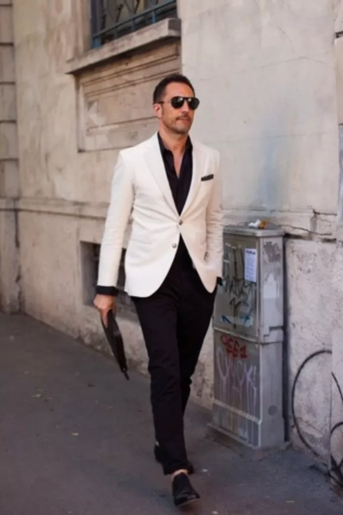 White Blazer + Black Dress Shirt + Black Trousers + Black Dress Shoes + Sunglasses + Clutch