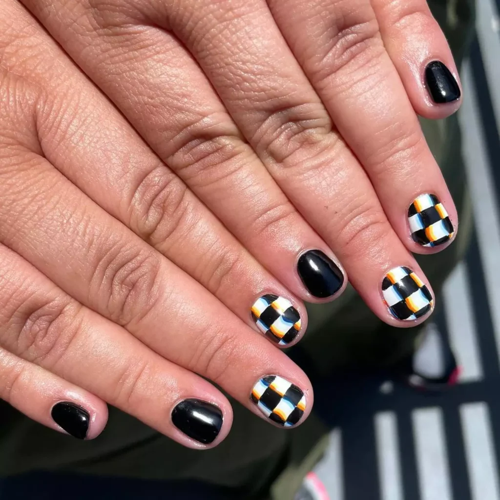 Cool black halloween nails with a trippy black and white glitch checkerboard design.