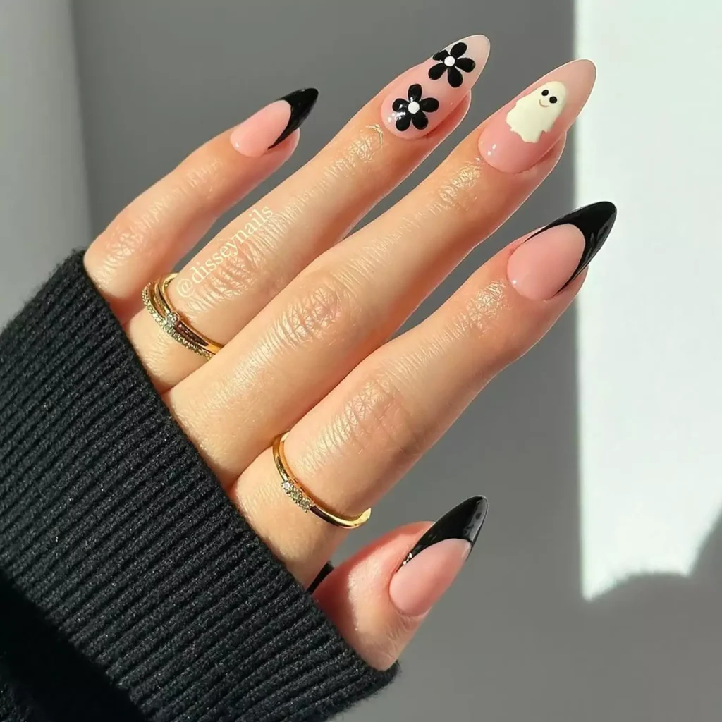 Chic black halloween nails with v-cut French tips and a cute white ghost accent.
