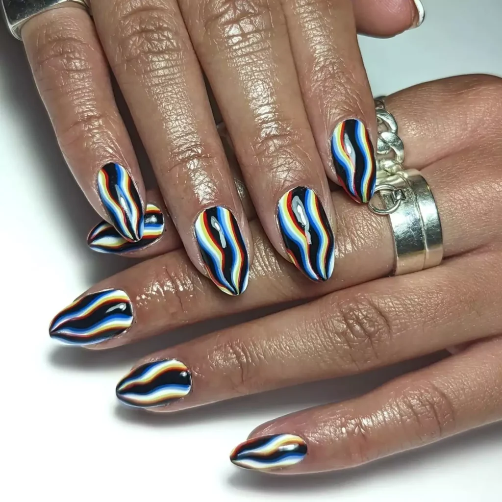 Trippy black halloween nails with wavy melting stripes in bright colors over a black base.